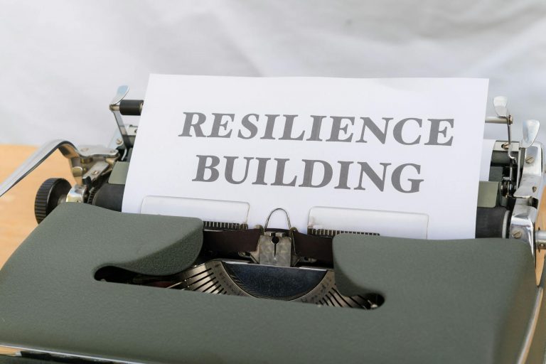 A vintage typewriter with a paper showing "Resilience Building," symbolizing personal growth and resilience.